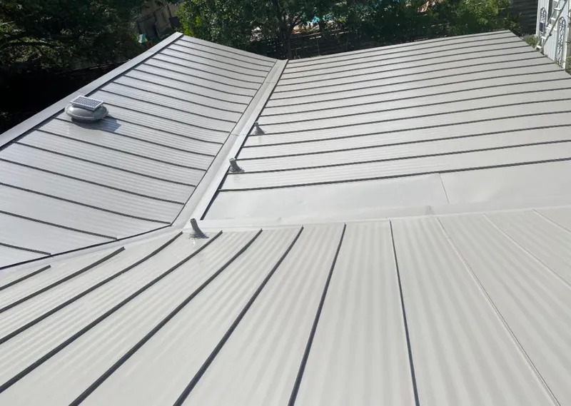 Solar attic fan installed on a metal roof for Roof Ventilation in Pinecrest